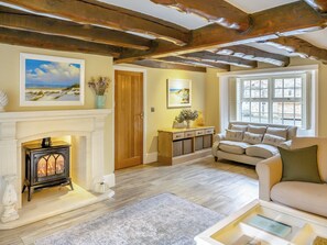 A cozy living room with a fireplace, a sofa, a coffee table, and a window with a view. - Steelclose House - UK48471 (Lintzford, near Rowlands Gill)