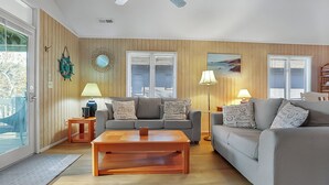 A living room with two sofas, a coffee table, and a lamp.