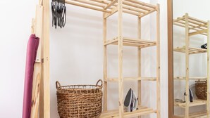 A wooden drying rack with shelves and a basket, placed against a white wall with a mirror reflecting the rack. - Pi502 Zona4 in Rio de Janeiro (Rio de Janeiro)