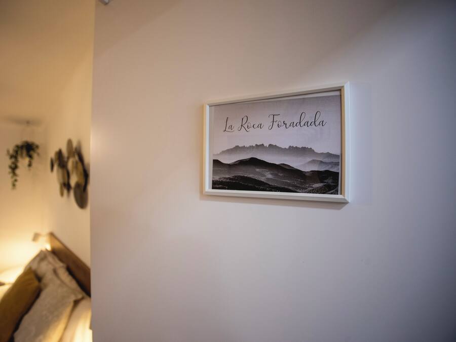 A framed picture with the text "La Roca Fósada" on a wall.
