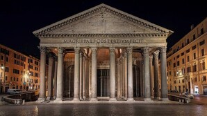 A classical building with a central entrance flanked by columns, surrounded by a paved square. - Rome Lux House guest rooms (Rome)