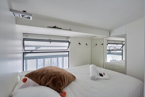 Laptop workspace, iron/ironing board, bed sheets
