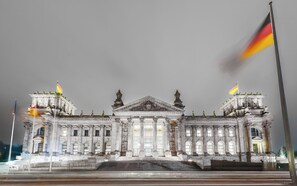 A grand building with classical architecture, featuring a central entrance with columns and a large inscription. - Limehome Berlin Sybelstraße (Berlin)