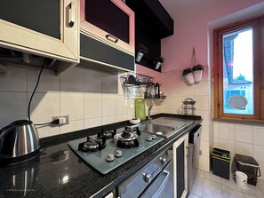 Fridge, stovetop, coffee/tea maker, cookware/dishes/utensils