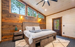 A peaceful king bedroom with natural touches and forest views, designed for the ultimate relaxation.