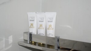 Three tubes of Aqua Shui Water products on a shelf. - Xenious Micro Dharmshala  (Dharamshala)