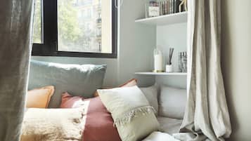 Laptop workspace, iron/ironing board, bed sheets