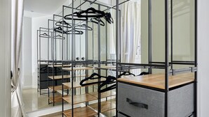 A modern bathroom with a glass shower enclosure, a wooden vanity, and a mirror cabinet. - Modern Parisian Apartment Center of Paris (Paris)