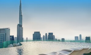 A high-rise building with a modern design, surrounded by other skyscrapers. - bnbme | Paramount Hotel Midtown | 2 Bdr (Dubai)