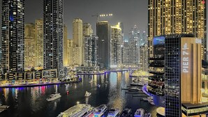 A waterfront cityscape with high-rise buildings, a marina with boats, and a prominent hotel named "Pier 7".