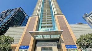 A tall building with a modern architectural design, featuring a prominent entrance labeled "8 Boulevard Walk." - bnbme | 8 Boulevard Walk | Studio (Dubai)