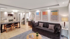 A modern apartment with a kitchen, dining area, and living room. - Modern 2-Bedroom in Central South Beach Location (Miami Beach)