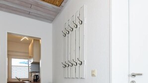 A compact kitchen with a refrigerator, a sink, and a window.