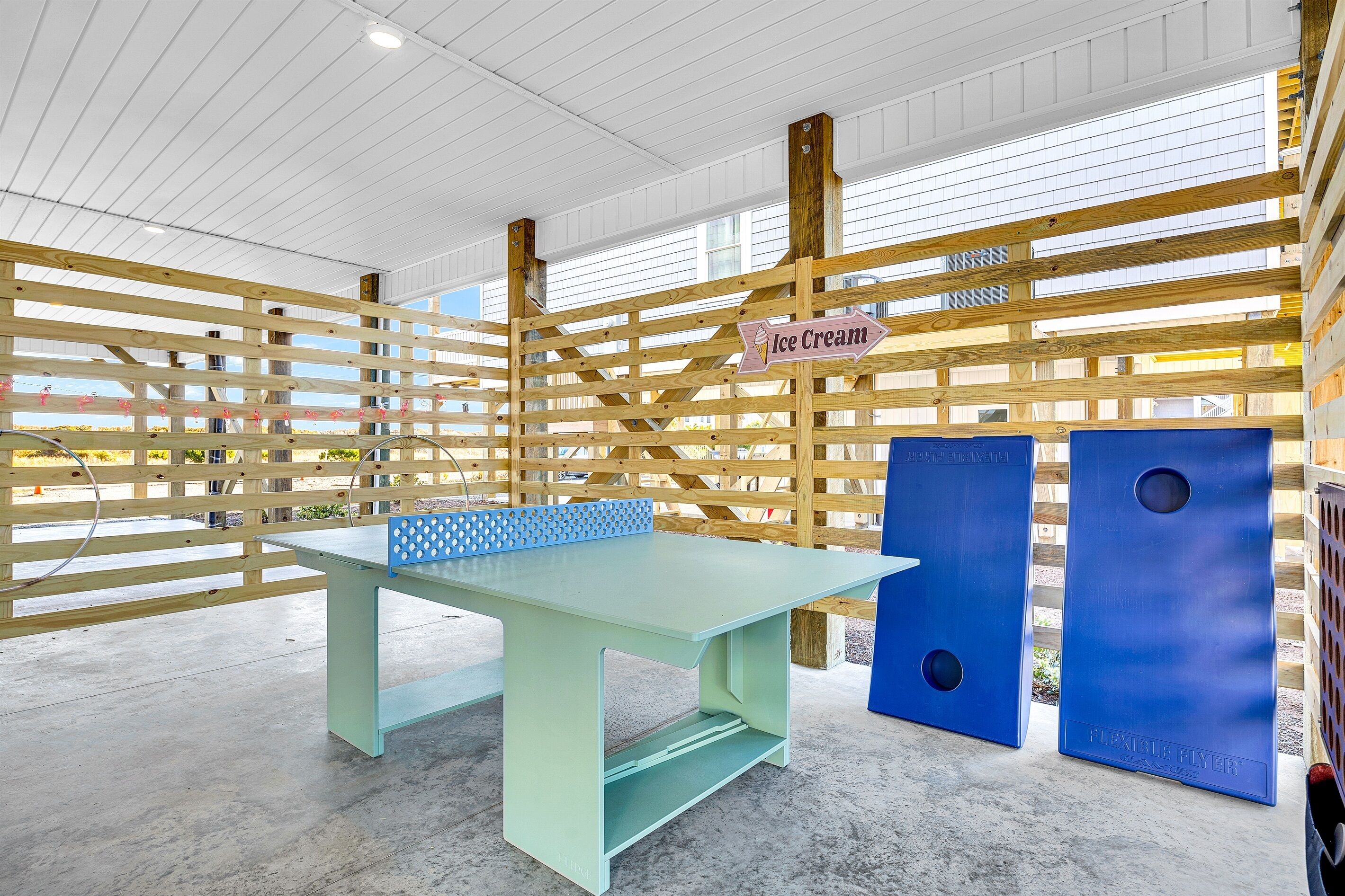 A wooden partition with a sign indicating an ice cream area, a light green table, and two blue doors labeled "Flexible River."