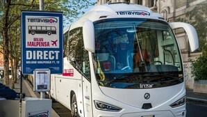 A white bus with the brand name 'Terravision' and 'Direct' on it, parked on a city street. - Hotel Demó (Milan)