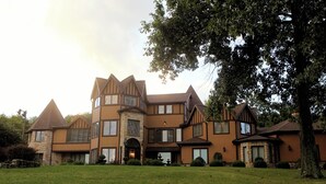 A large, multi-story house with a prominent stone entrance, multiple windows, and a well-maintained lawn. - The Grand Estate in Freeport PA just NE of Pittsburgh Pa Private Pool (Freeport)