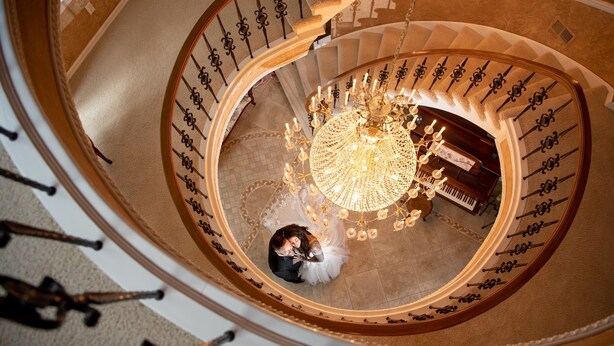 A grand spiral staircase with a chandelier, a piano, and a couple kissing. - The Grand Estate in Freeport PA just NE of Pittsburgh Pa Private Pool (Freeport)