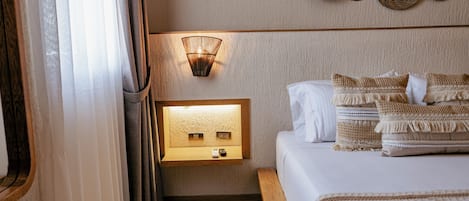 A bedroom with a bed, bedside table, wall-mounted light, and a wall with woven baskets.