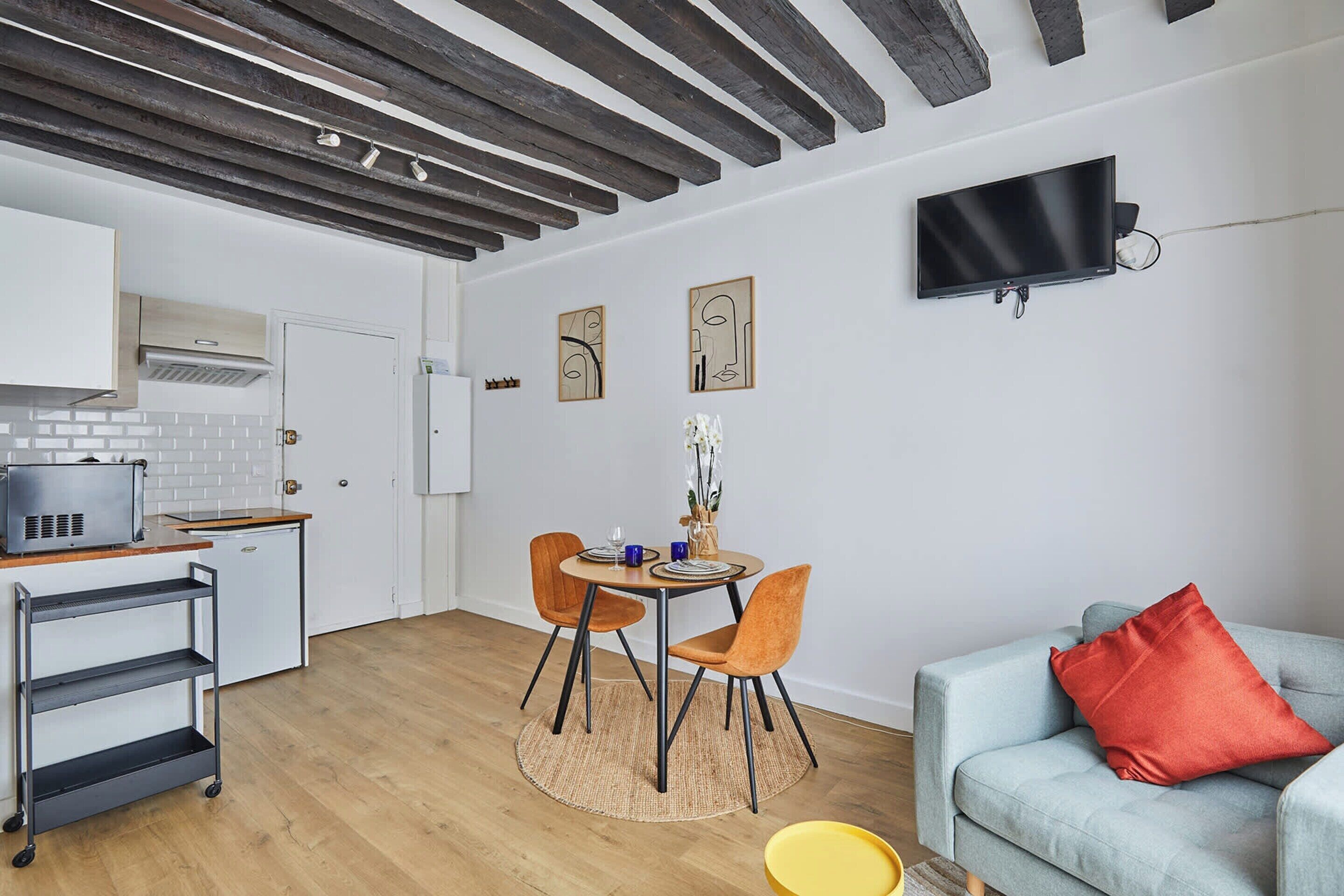 A compact living space with a kitchen, dining area, and seating area.