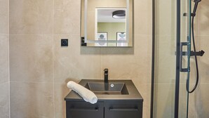 A bathroom with a sink, mirror, and shower. - Sublime and new Apartment Le Marais / Beaubourg (Paris)