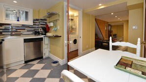 A compact kitchen with a dishwasher, a sink, and a washing machine in the adjacent room. - Specious one bedroom apartment in upscale neighbourhood in Leaside Toronto.  (Toronto)