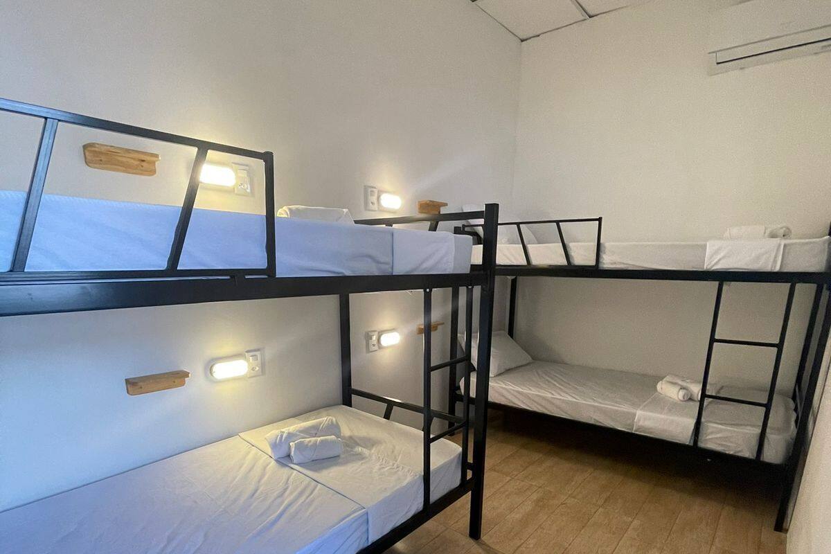 Un dormitorio con literas, una ventana con vistas y un estante de madera.