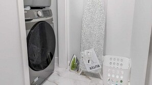 A laundry room with a washing machine, dryer, and a drying rack. - President's Choice: Lofty Guest Suite Near Airport  (Edmonton)