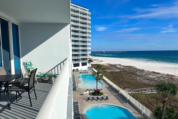 Balcony with seating and views of pool, beach and Gulf of Mexico.