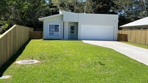 A single-story house with a garage, a front door, and a small porch.