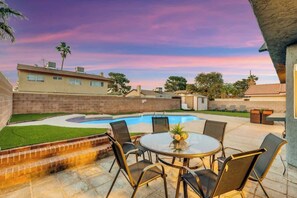 Enjoy a refreshing dip in the pool surrounded by a patio and lush garden.