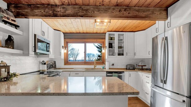 A modern kitchen with a large island, stainless steel appliances, and a wooden ceiling. - Townhouse, Mountain Views & Ski Access, Kingswood (Quechee)