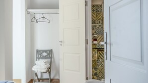 A bathroom with a bathtub, a shower, and a toilet. There is a towel rack with a towel hanging on it. The floor is wooden, and the walls are white. - NA Beautiful View Rooftop-B&B - Double Room with Sea View (Napoli)