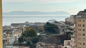 A coastal cityscape with a mix of historical and modern buildings, including a prominent dome structure and a large body of water in the background. - NA Beautiful View Rooftop-B&B - Double Room with Sea View (Napoli)