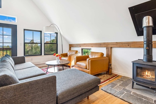 Upstairs living room with a wood-burning stove and valley views