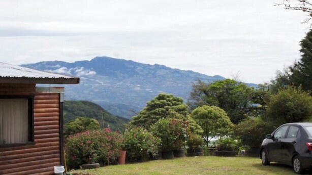 Una cabaña de madera con vistas a las montañas.