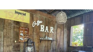 A rustic wooden bar with a vintage lantern, a sign reading "Imperial 1924", and a "Coffee BAR" sign.