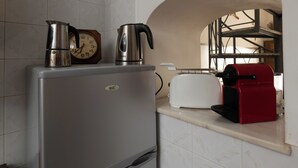 A kitchen with a refrigerator, a coffee maker, a toaster, and a clock. - Casa Del Sarto (Sperlinga)