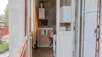 A laundry room with a washing machine, a dryer, and a water heater.