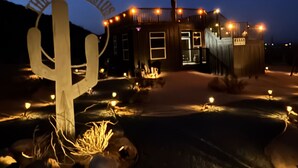 A building with a large cactus sculpture in front, labeled "The Black Cactus." - Magical Vibes on 5 Acres with panoramic views. (Joshua Tree)
