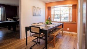 A dining area with a long table, chairs, and a bench. - River Run Retreat - Cowboy Pool, Fire Pit & Pool Table! Close to Campus & River (San Marcos)