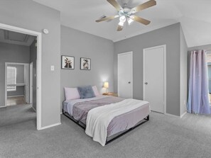 Relax in this exceptionally spacious bedroom, featuring a sleek modern bed setup with plush linens and generous closet space. - Spacious & Stylish 4 BR house Round Rock (Round Rock)