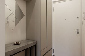A modern bathroom with a mirror, a towel rack, and a toilet.