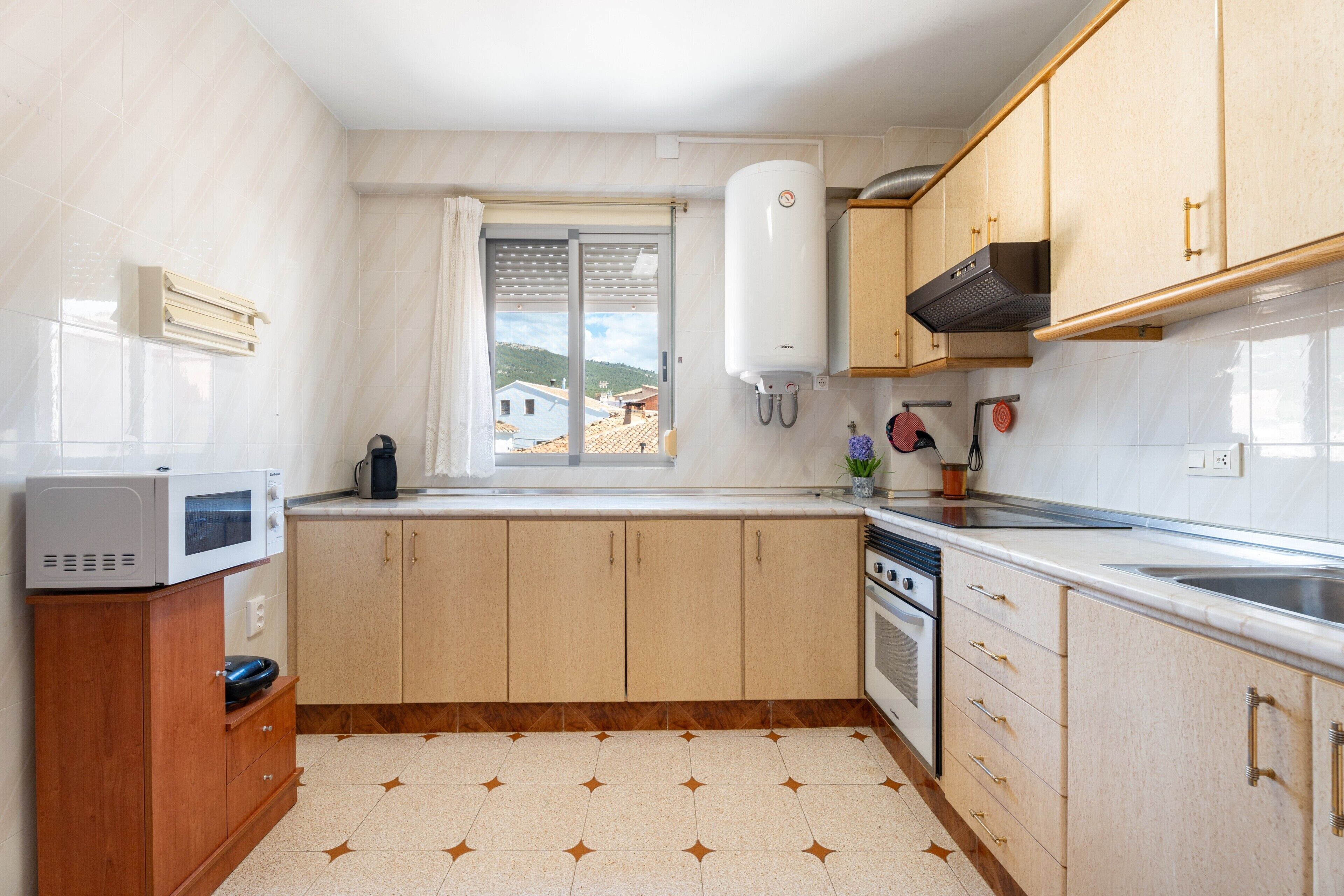 Fridge, microwave, coffee/tea maker, cookware/dishes/utensils