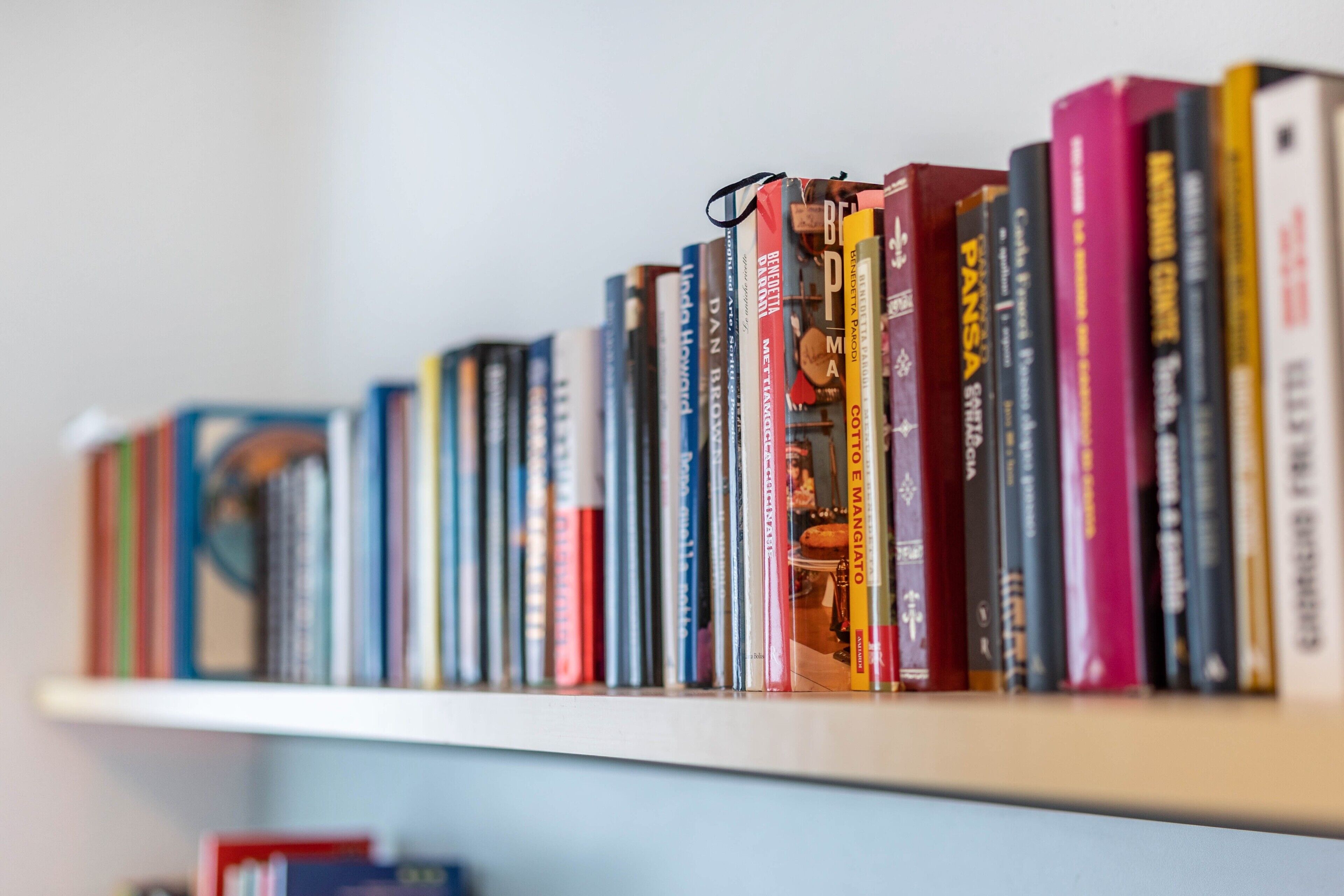 A bookshelf with a variety of books.