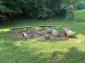 A picnic area with benches and rocks.