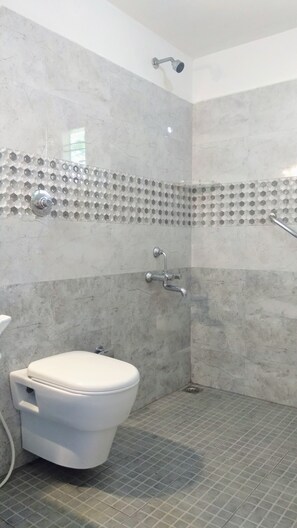 A bathroom with a toilet, shower, and tiled floor. - Heights Farm Stay - Coffee Estate Stay (Madikeri)