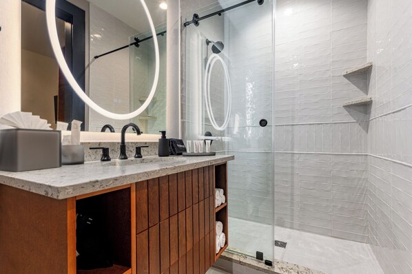 Bathroom 2 - Spacious walk-in shower with sleek glass doors and modern fixtures. - 4BR Large Space for 14 in Prime Location | The Mayfair (New Orleans)
