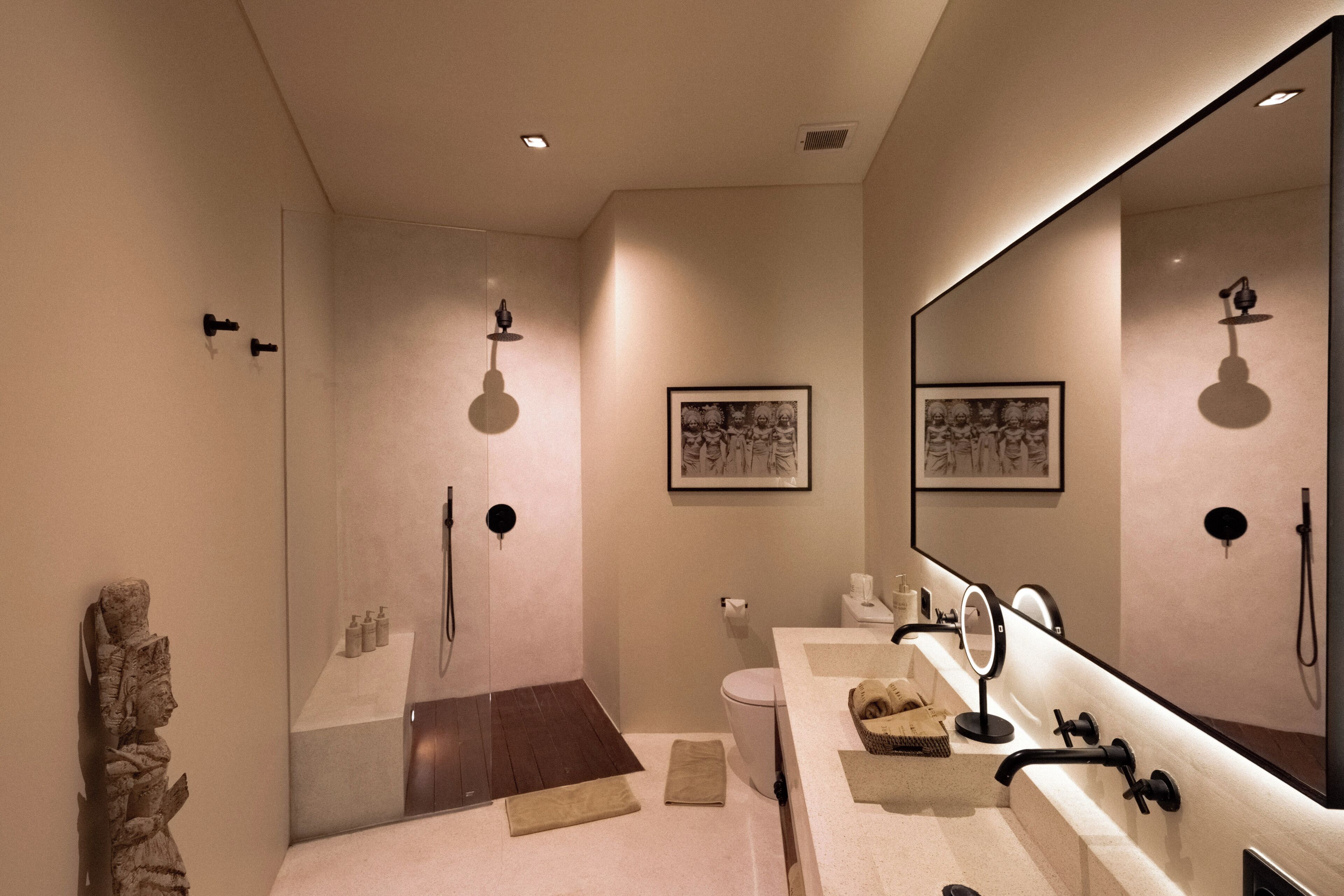 A modern bathroom with a shower, toilet, and vanity.