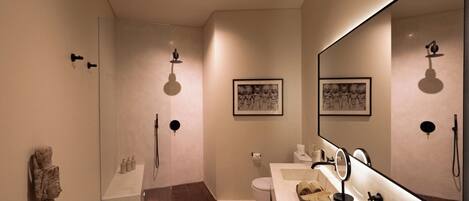 A modern bathroom with a shower, toilet, and vanity.