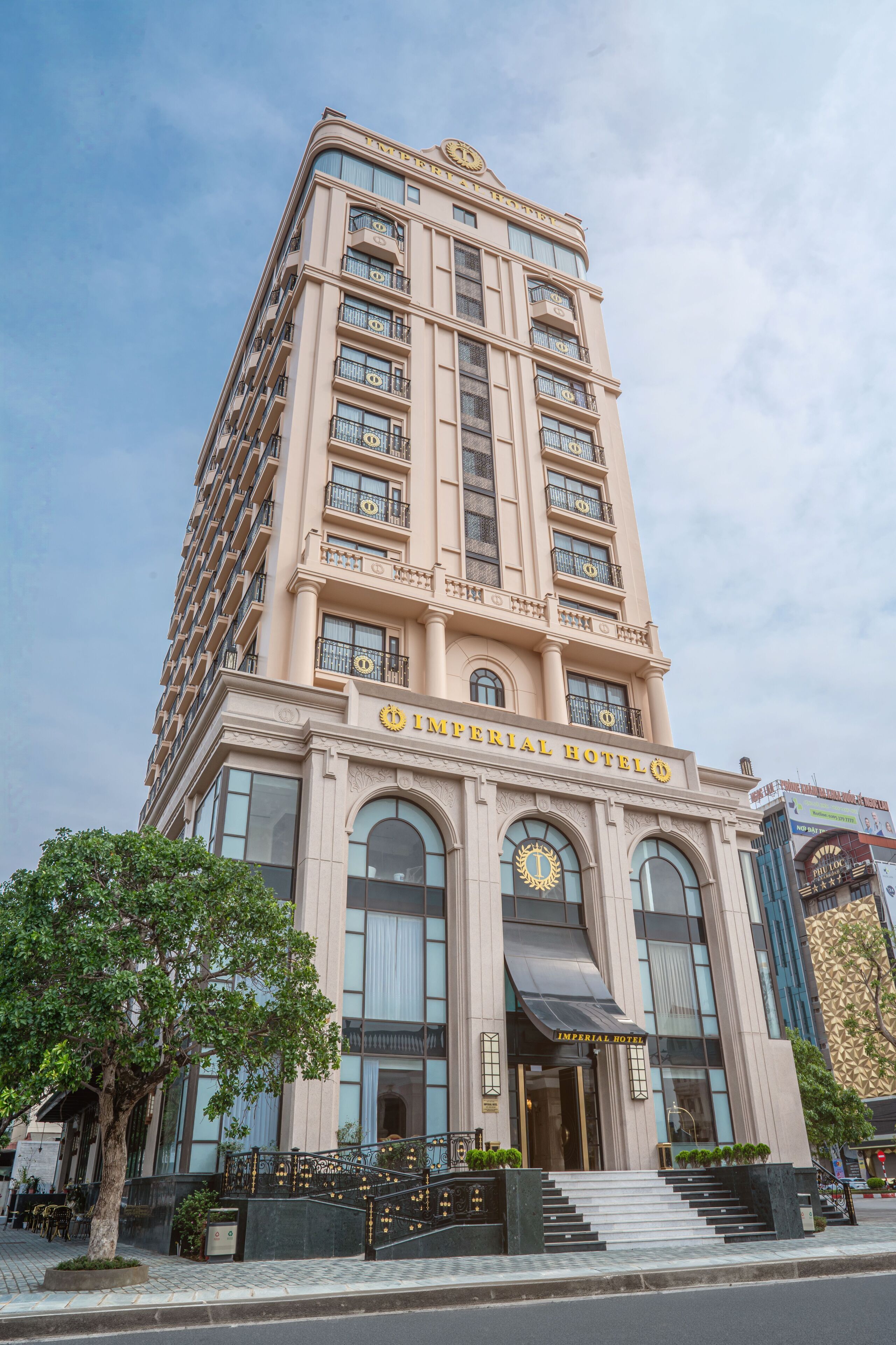 A tall, beige building with the sign "Imperial Hotel" at the top. It has multiple balconies and large windows.